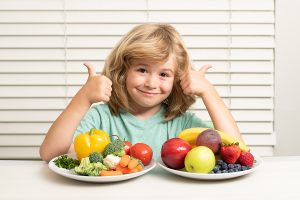 happy child with fruits and vegetables